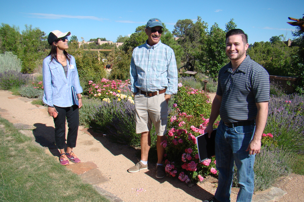 Cristina Salvador (Collections Manager), Jay Geiger (SFBG Member and Volunteer), and Nicholas Maestas, Constituent Liaison for Congressman Ben R. Luján, in the Orchard Gardens.